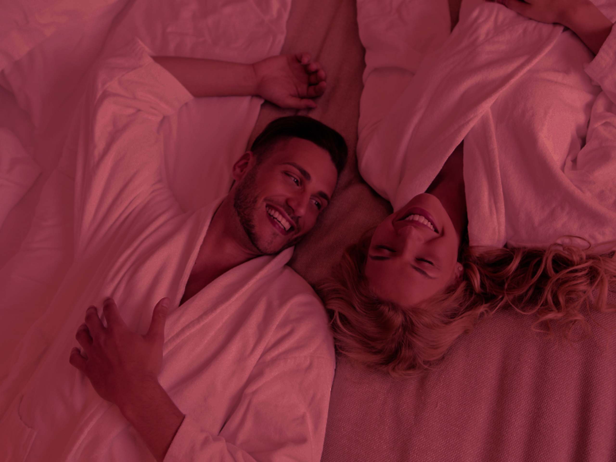 A couple is lying on the bed